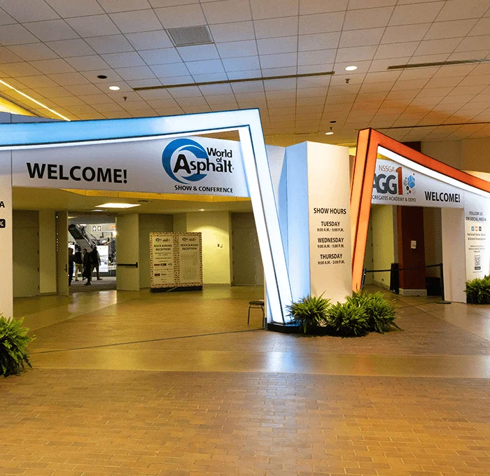 Welcome sign on window with World of Asphalt and AGG1 logo