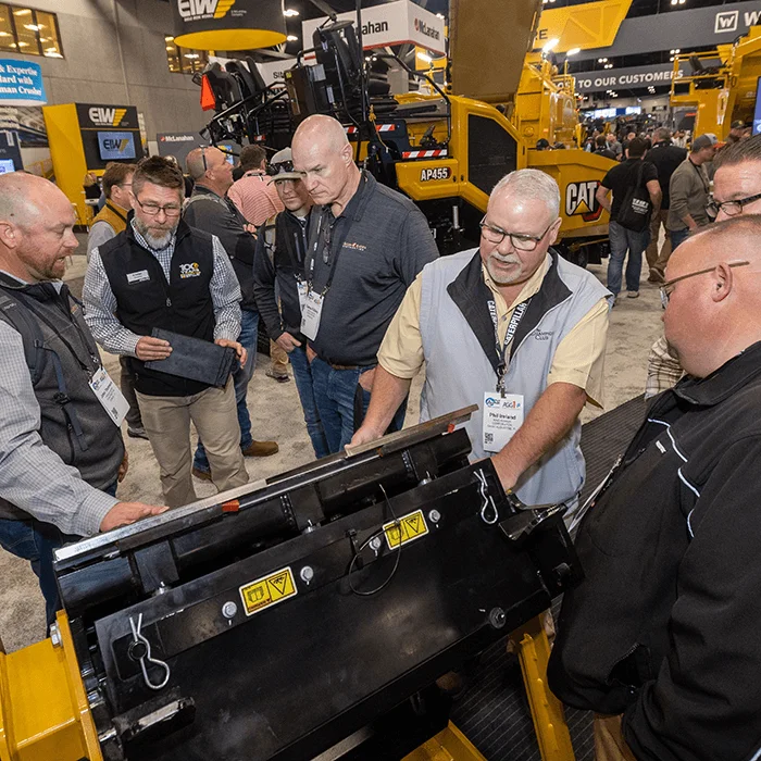 Two guys talking about equipment at World of Asphalt